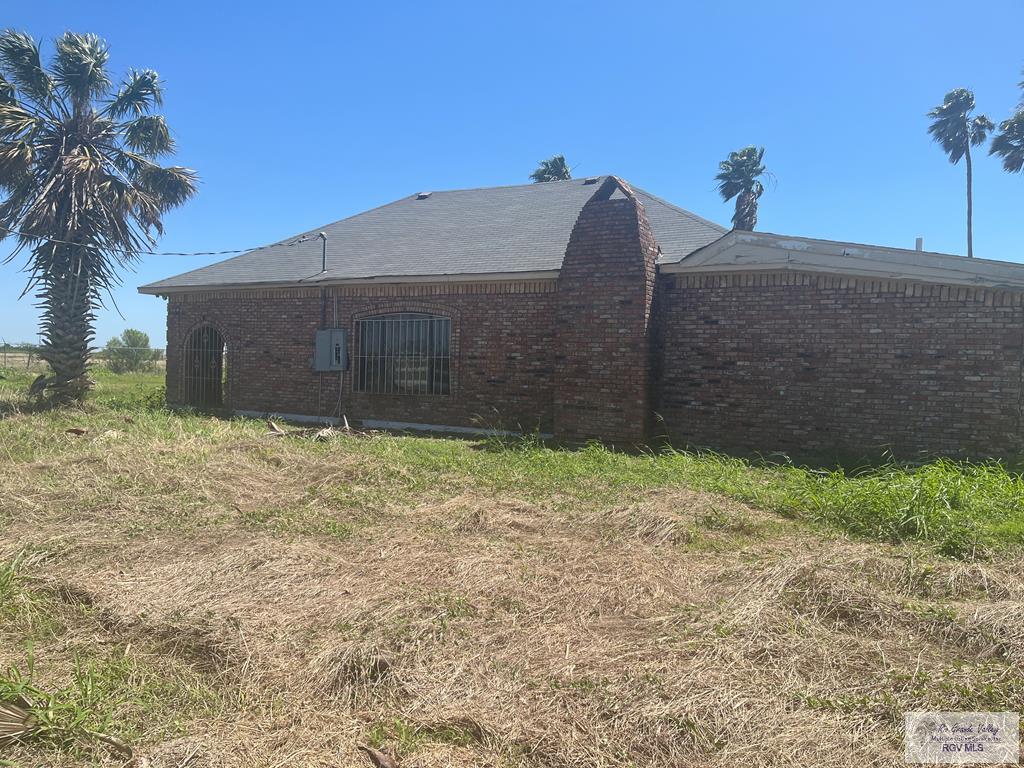 back of house featuring brick siding