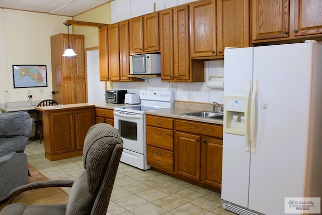 kitchen featuring sink, light tile patterned flooring, hanging light fixtures, and white appliances