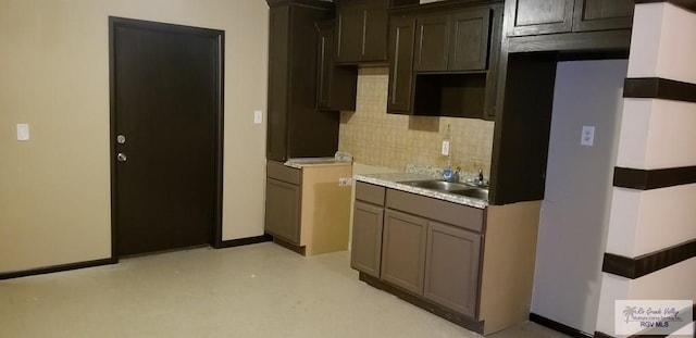 1287 Delpha Dr, Brownsville, TX 78521 - kitchen with tasteful backsplash, a sink, and baseboards