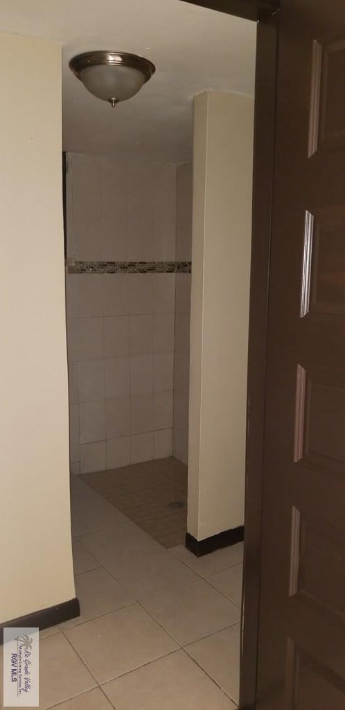 1287 Delpha Dr, Brownsville, TX 78521 - hall with light tile patterned flooring and baseboards