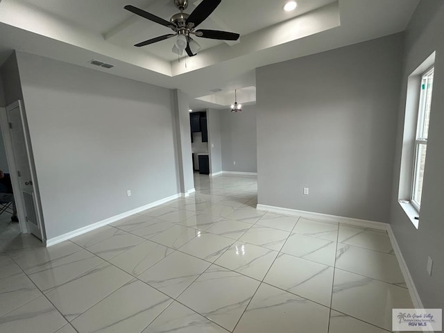 spare room featuring visible vents, baseboards, and marble finish floor