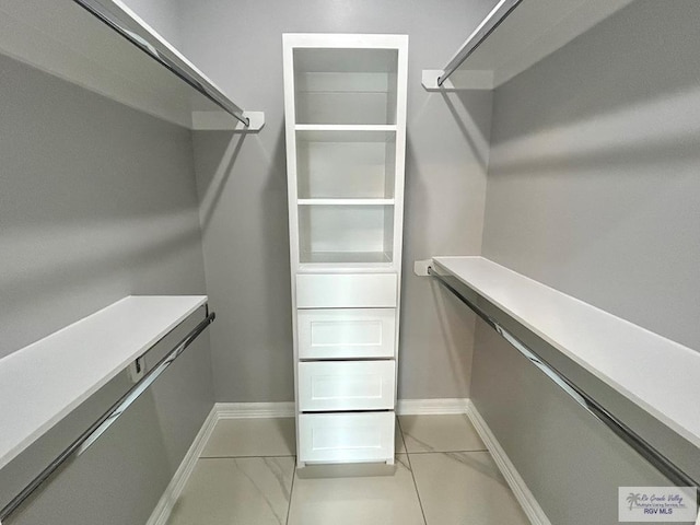 spacious closet with marble finish floor