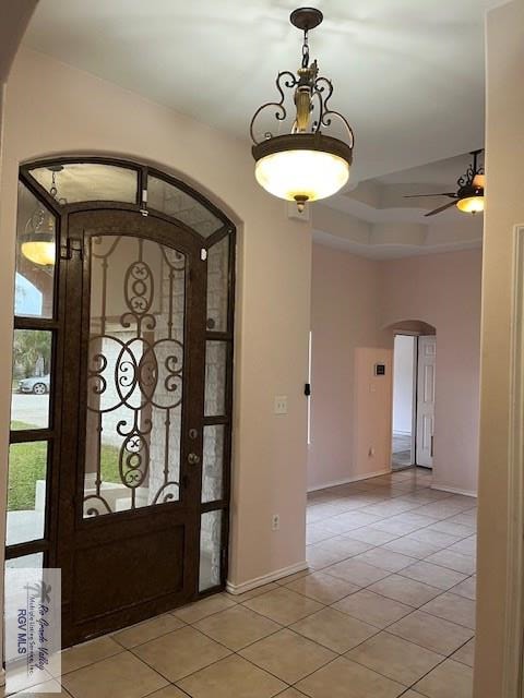 entrance foyer with light tile patterned flooring and ceiling fan