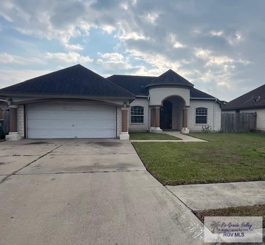 single story home with a garage and a front yard