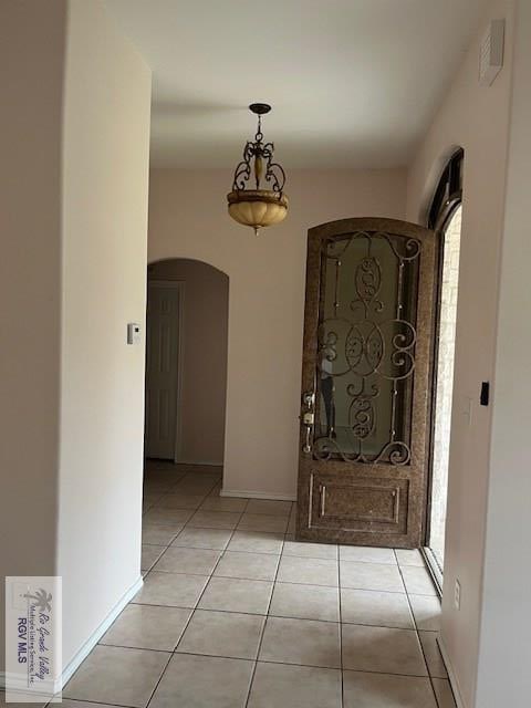 entryway with light tile patterned floors