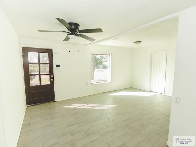 empty room featuring light wood-type flooring and ceiling fan