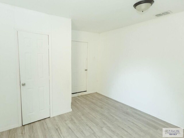 unfurnished bedroom featuring light wood-type flooring