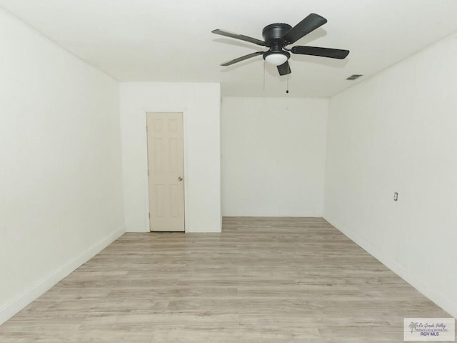 empty room with ceiling fan and light wood-type flooring