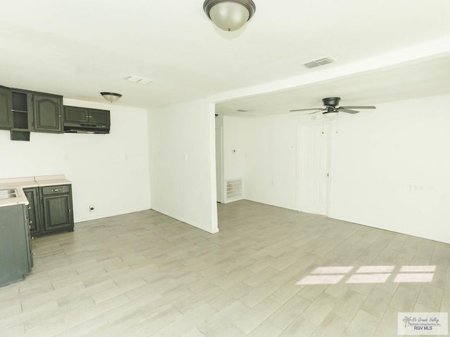 interior space with ceiling fan and light hardwood / wood-style floors