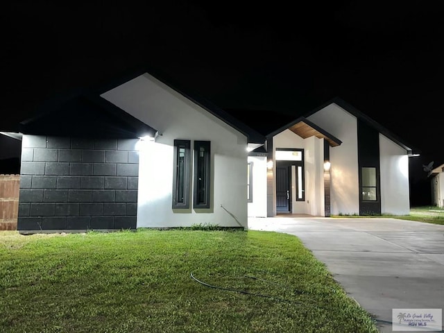 view of front of home with a lawn