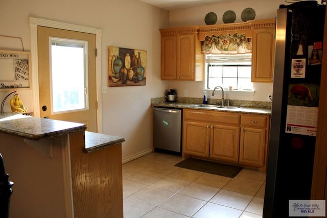 1272 Costa Del Sol Dr, Brownsville, TX 78520 - kitchen featuring stainless steel appliances, a sink, light tile patterned floors, baseboards, and a breakfast bar