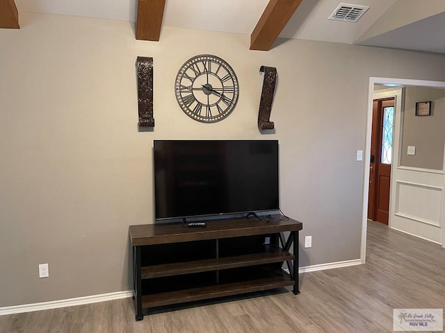 interior details featuring baseboards, visible vents, beam ceiling, and wood finished floors