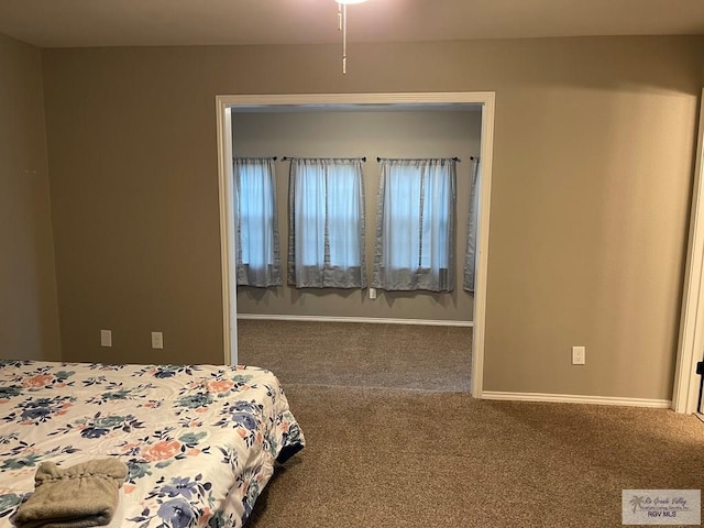 carpeted bedroom featuring baseboards