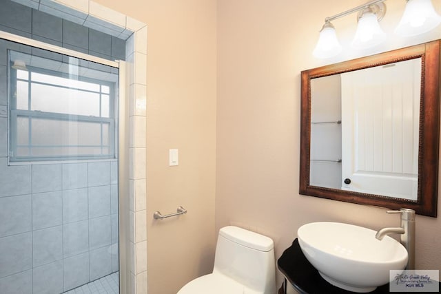 bathroom with a shower with door, vanity, and toilet