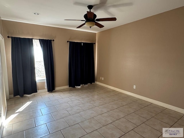 tiled spare room featuring ceiling fan