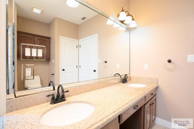 bathroom with vanity and toilet