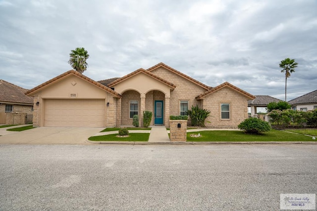 view of front of home with a front yard and a garage