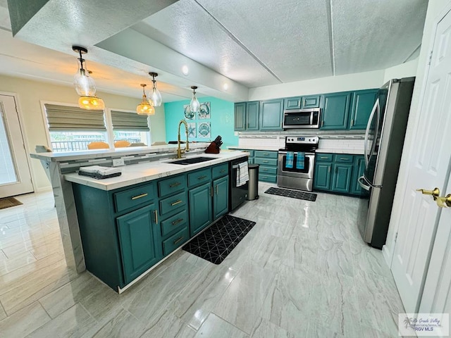 kitchen with backsplash, a textured ceiling, stainless steel appliances, sink, and pendant lighting