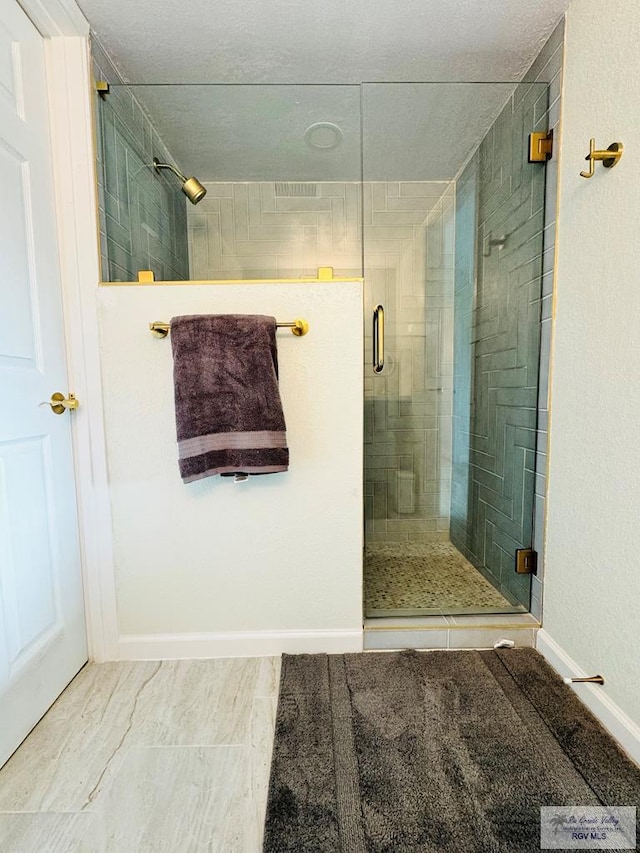 bathroom featuring a shower with door