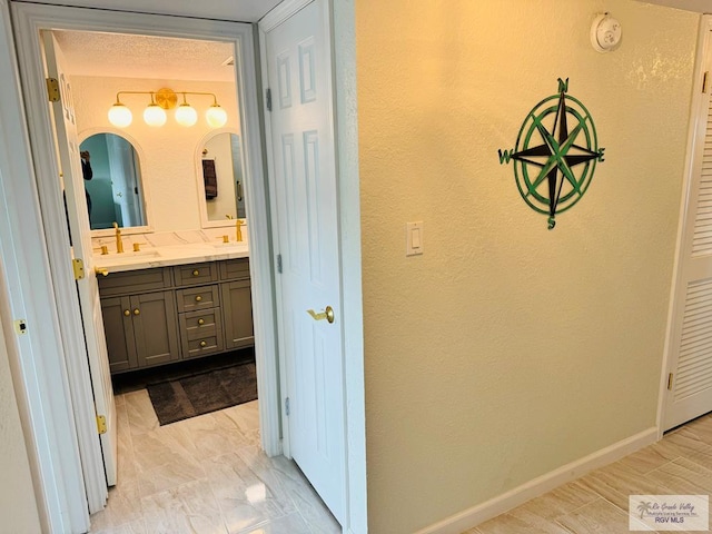 bathroom featuring vanity and a textured ceiling