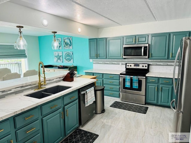 kitchen featuring decorative light fixtures, sink, decorative backsplash, and stainless steel appliances