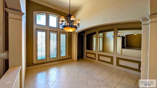 5805 Acacia, Harlingen, TX 78552 - unfurnished room featuring ornamental molding, plenty of natural light, and a chandelier