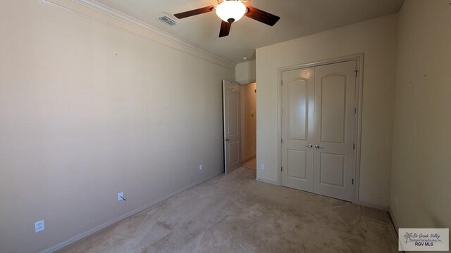 5805 Acacia, Harlingen, TX 78552 - unfurnished bedroom with visible vents, baseboards, a closet, crown molding, and light colored carpet