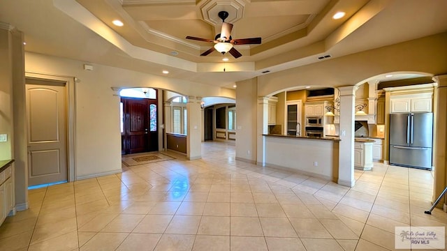 5805 Acacia, Harlingen, TX 78552 - kitchen with ornate columns, arched walkways, ceiling fan, stainless steel appliances, and dark countertops