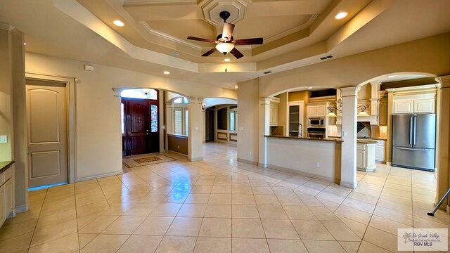 5805 Acacia, Harlingen, TX 78552 - kitchen featuring ornate columns, arched walkways, ceiling fan, stainless steel appliances, and dark countertops