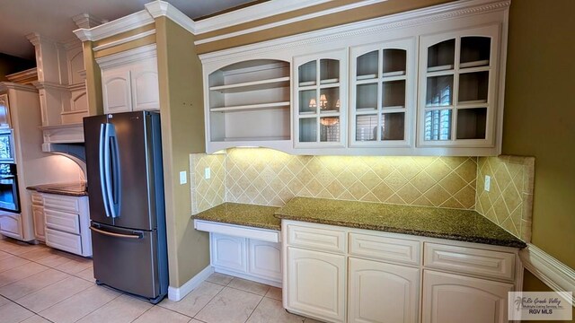 5805 Acacia, Harlingen, TX 78552 - kitchen with open shelves, light tile patterned floors, dark stone countertops, and freestanding refrigerator