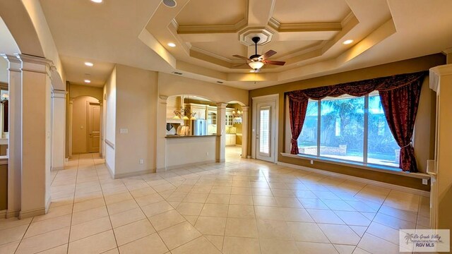 5805 Acacia, Harlingen, TX 78552 - unfurnished room featuring arched walkways, ornamental molding, a ceiling fan, and ornate columns