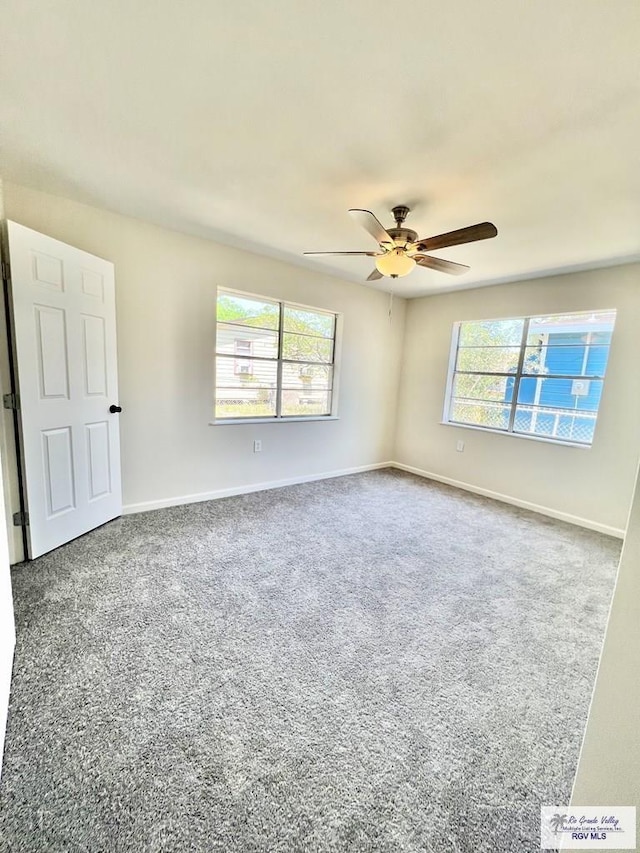 unfurnished room featuring ceiling fan, a healthy amount of sunlight, and carpet flooring