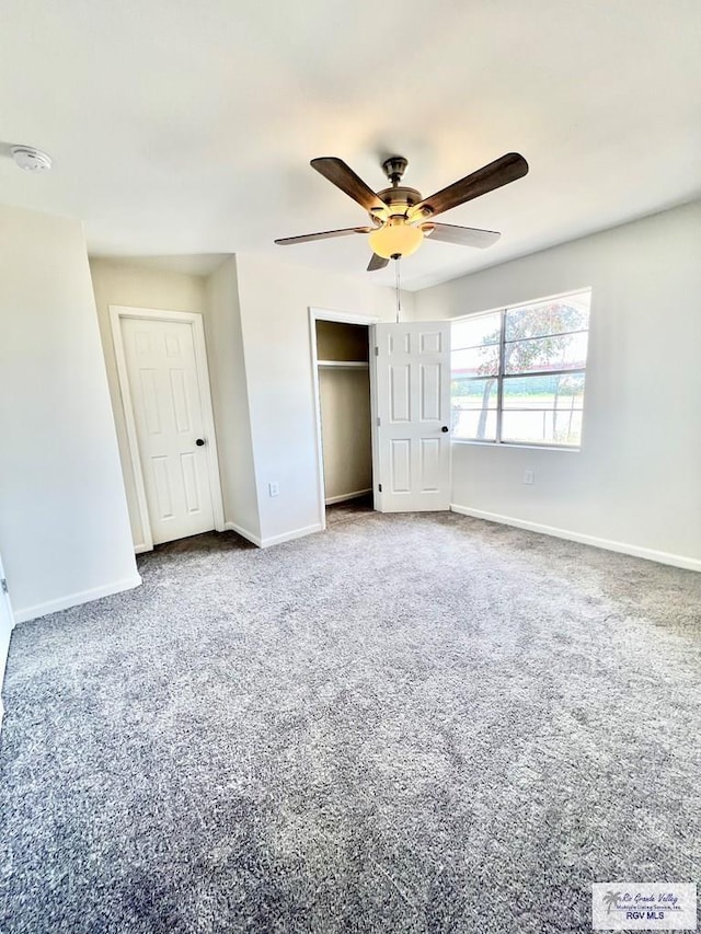 unfurnished bedroom featuring a closet, ceiling fan, and carpet