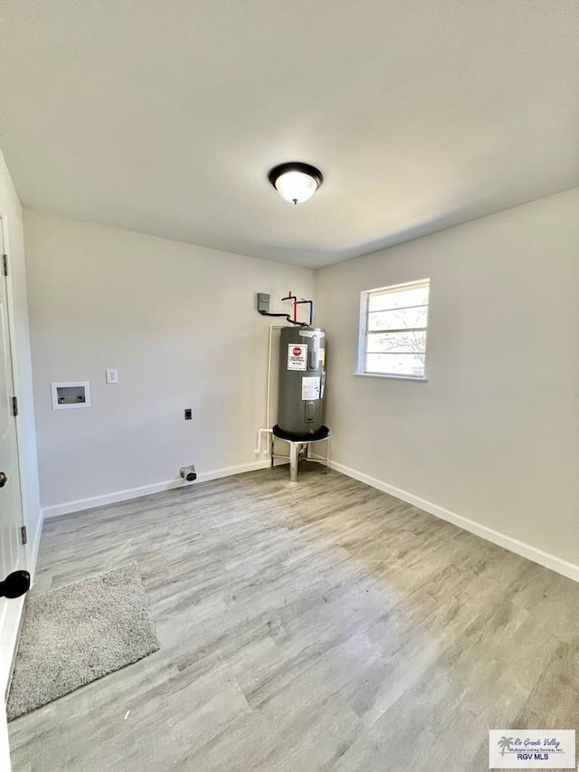 washroom with washer hookup, hardwood / wood-style flooring, water heater, and hookup for an electric dryer