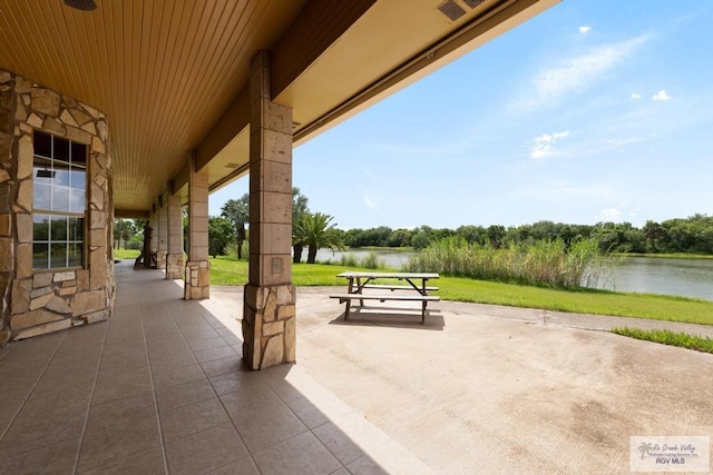 exterior space featuring a patio area and a water view