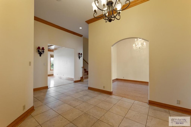 unfurnished room with a chandelier, light tile patterned floors, and ornamental molding