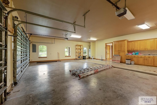 garage with electric panel and a garage door opener