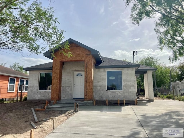 property in mid-construction featuring roof with shingles