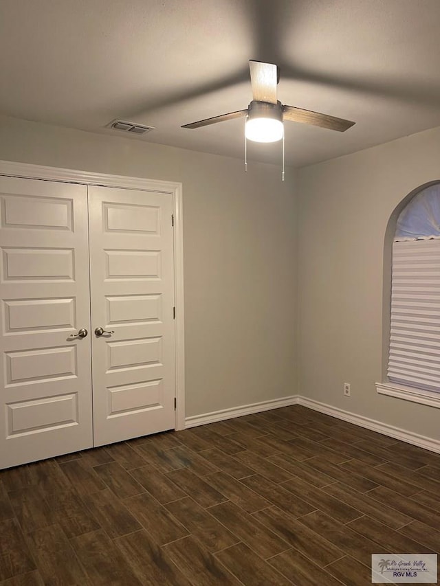 917 S Houston Dr, Harlingen, TX 78550 - empty room featuring visible vents, dark wood-type flooring, and ceiling fan