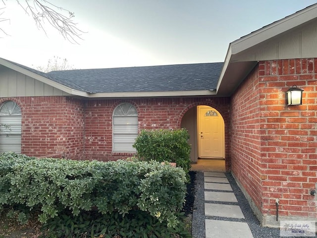 917 S Houston Dr, Harlingen, TX 78550 - entrance to property featuring brick siding and roof with shingles