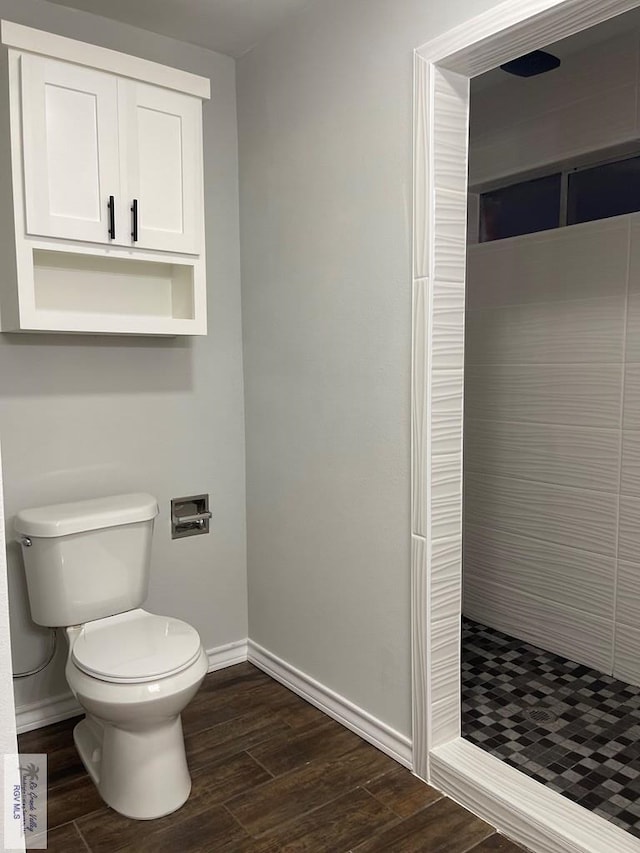 917 S Houston Dr, Harlingen, TX 78550 - full bathroom featuring a shower stall, toilet, baseboards, and wood finished floors