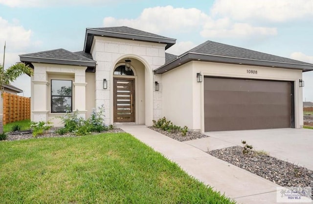 view of front of home with a front yard and a garage