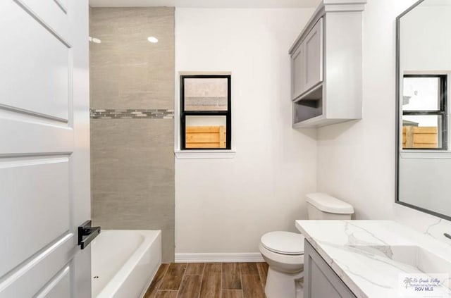 bathroom featuring toilet, vanity, and hardwood / wood-style flooring