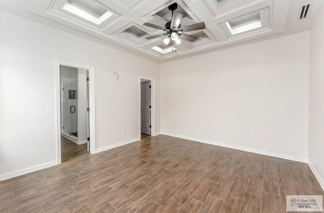 spare room featuring ceiling fan, beamed ceiling, wood-type flooring, and coffered ceiling