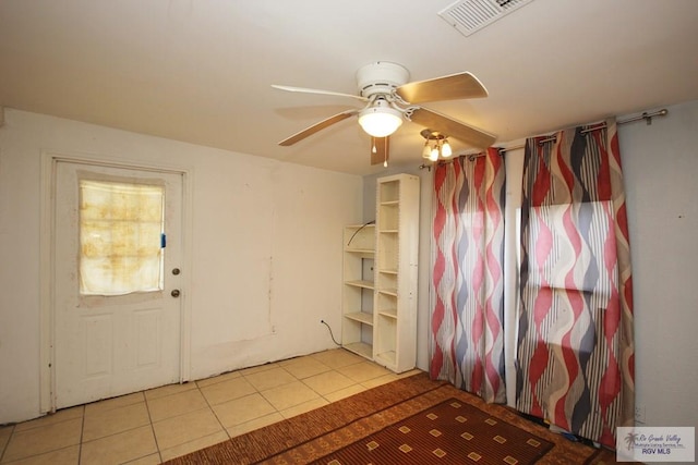 825 E Vinson Ave, Harlingen, TX 78550 - spare room with tile patterned floors and a ceiling fan