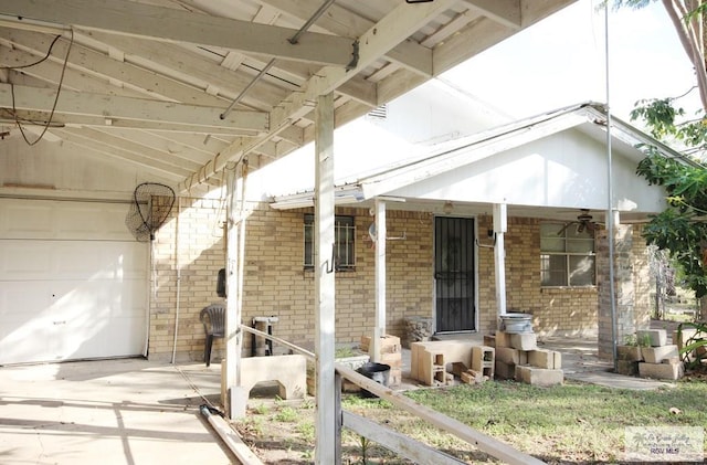 825 E Vinson Ave, Harlingen, TX 78550 - view of front of property featuring a porch, brick siding, and a garage