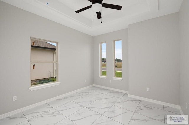 1606 Arden St, Mercedes, TX 78570 - unfurnished room with a raised ceiling, light marble finish floors, a ceiling fan, and baseboards