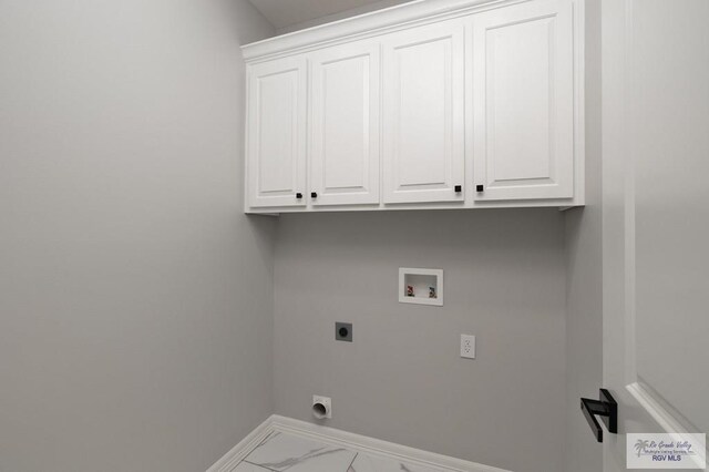 1606 Arden St, Mercedes, TX 78570 - washroom featuring hookup for an electric dryer, baseboards, cabinet space, hookup for a washing machine, and marble look tiles