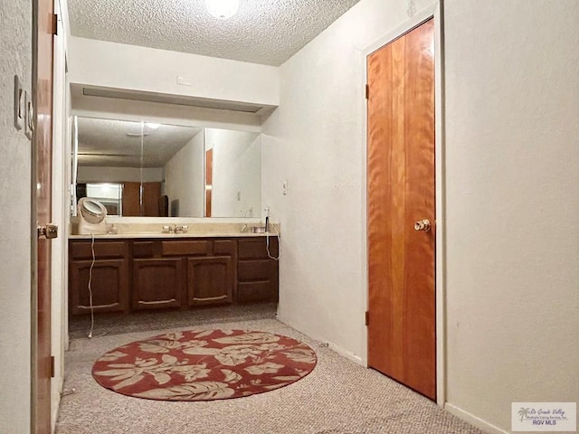 bathroom with vanity and a textured ceiling