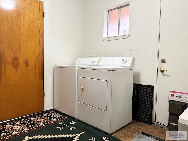 clothes washing area featuring washer and clothes dryer